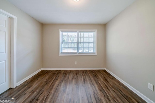 spare room with dark hardwood / wood-style floors