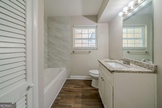 bathroom with hardwood / wood-style floors, vanity, and toilet