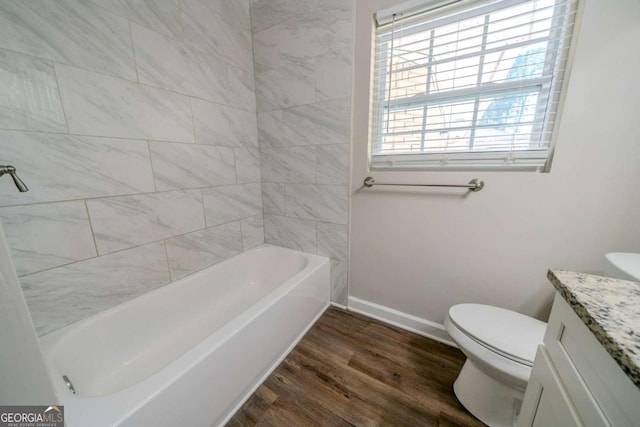 bathroom with toilet, vanity, and hardwood / wood-style flooring