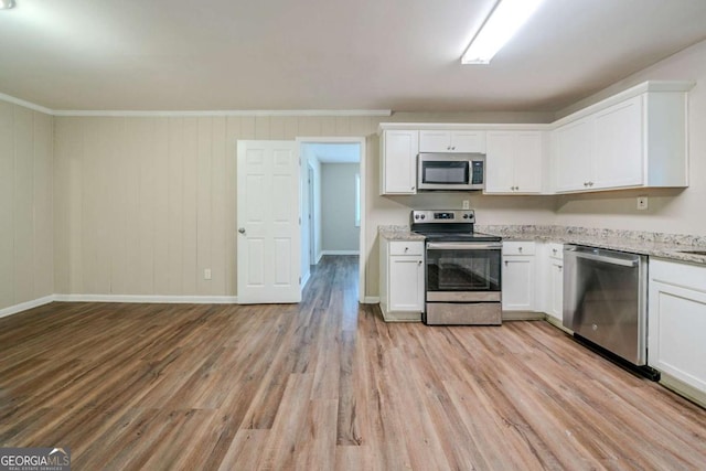 kitchen featuring white cabinets, light stone counters, stainless steel appliances, and light hardwood / wood-style flooring