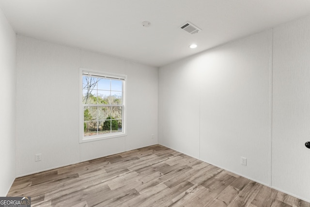 unfurnished room with light hardwood / wood-style flooring