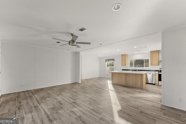 unfurnished living room with ceiling fan and light hardwood / wood-style floors