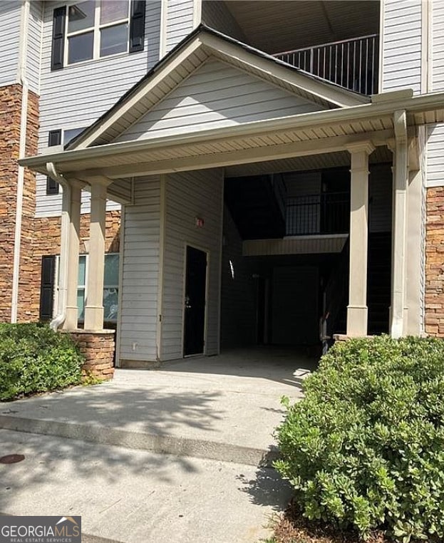 view of side of property with a carport