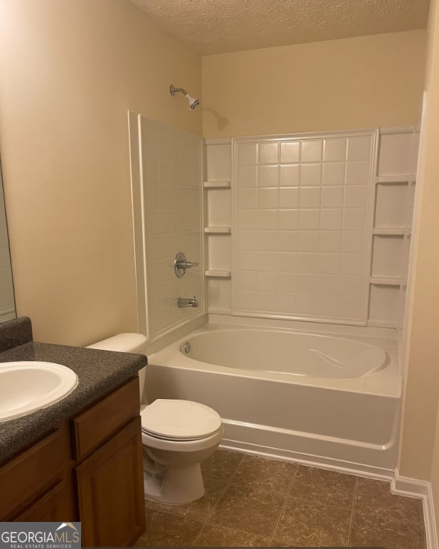 full bathroom featuring shower / bathing tub combination, vanity, toilet, and a textured ceiling