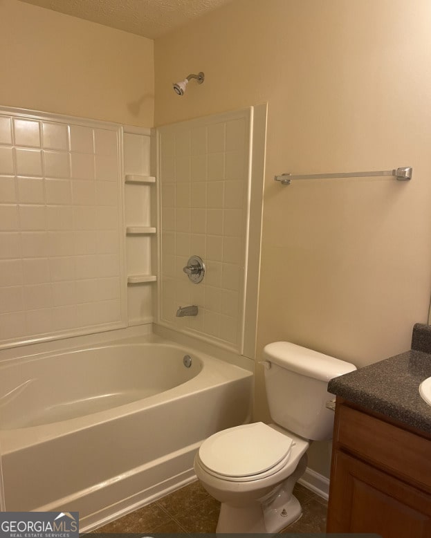 full bathroom with vanity, washtub / shower combination, tile patterned flooring, toilet, and a textured ceiling