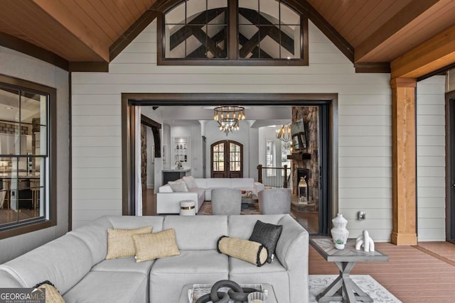 interior space with wood walls, wooden ceiling, and vaulted ceiling