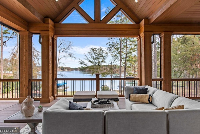 sunroom with lofted ceiling, a water view, and wooden ceiling