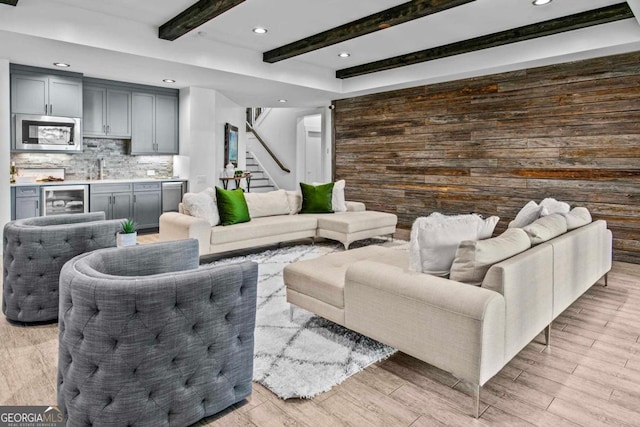 living room featuring beamed ceiling and beverage cooler