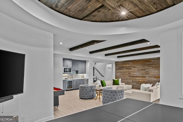 living room with beamed ceiling, wine cooler, wooden ceiling, and pool table