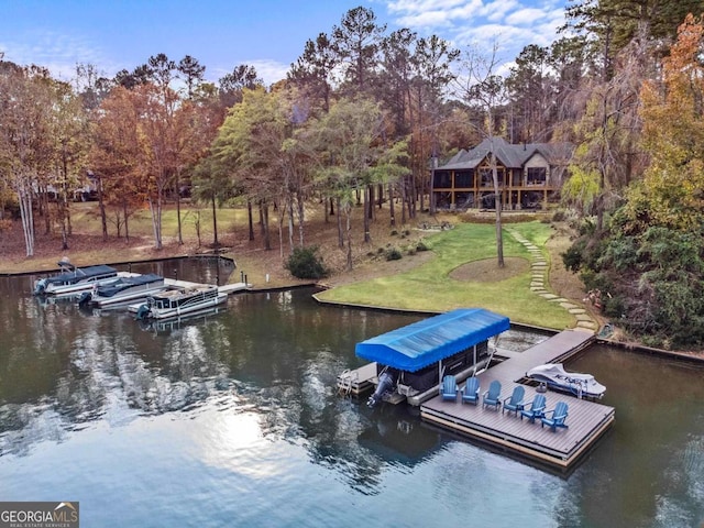 dock area with a water view and a lawn