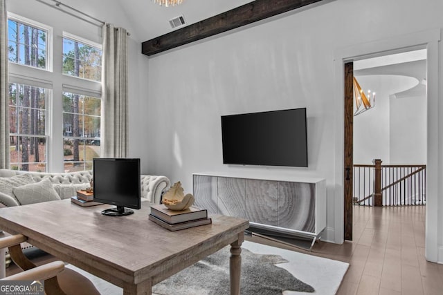 office featuring lofted ceiling with beams, a chandelier, and wood-type flooring