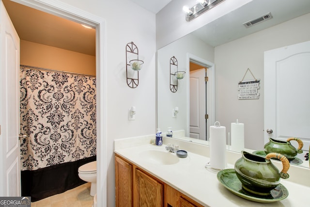 bathroom with visible vents, curtained shower, toilet, and vanity