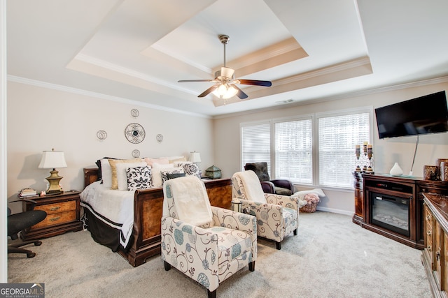 carpeted bedroom featuring visible vents, crown molding, a raised ceiling, and ceiling fan