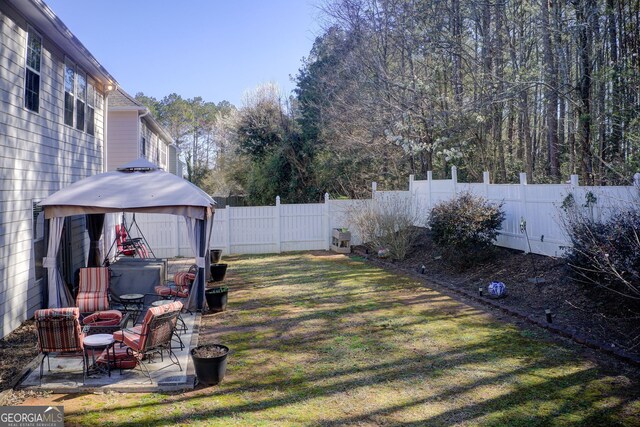 view of yard with a gazebo, a fenced backyard, and a patio