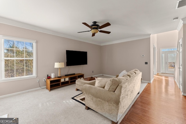 living room featuring ceiling fan and crown molding