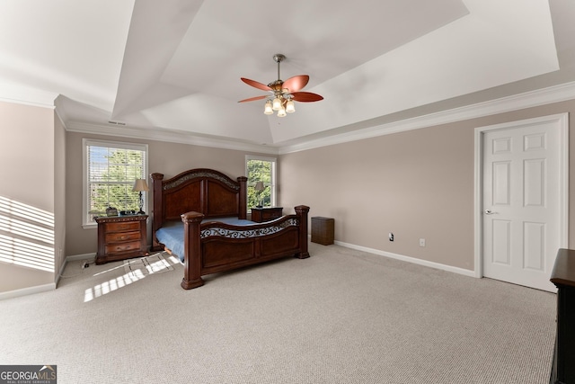 bedroom featuring light carpet, crown molding, a raised ceiling, and multiple windows