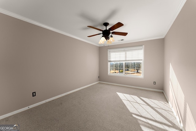 empty room featuring ceiling fan, crown molding, and light colored carpet