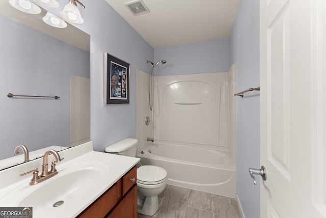 full bathroom with toilet, vanity, and tub / shower combination