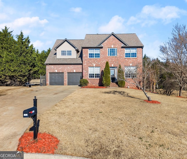 view of front of property featuring a front yard and a garage