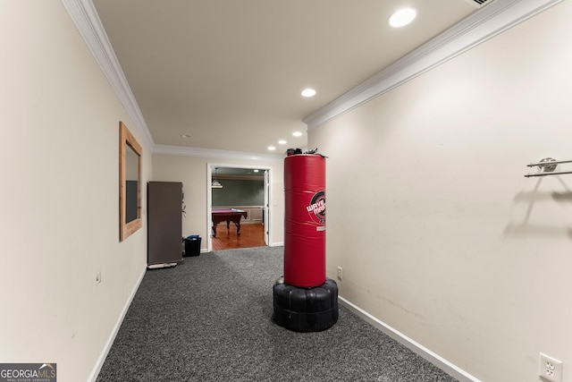 hallway featuring dark carpet and crown molding