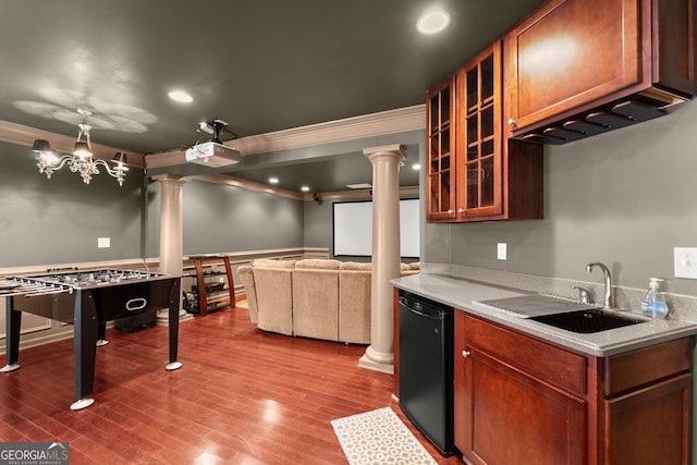 kitchen with a notable chandelier, sink, black dishwasher, ornamental molding, and decorative columns