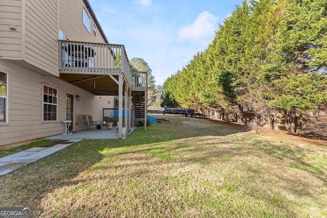 view of yard with a deck and a patio area