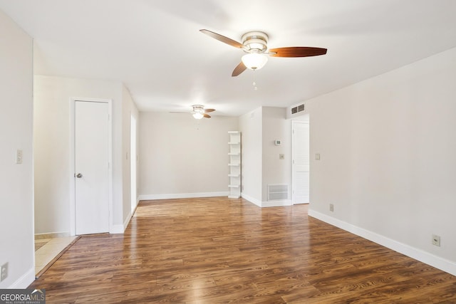 unfurnished room featuring ceiling fan and dark hardwood / wood-style flooring