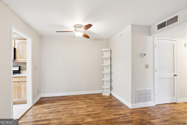 unfurnished room with hardwood / wood-style floors, a textured ceiling, and ceiling fan