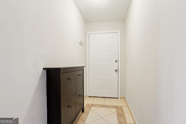 doorway to outside with light tile patterned floors