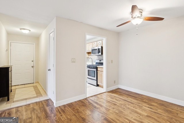 interior space with ceiling fan and light hardwood / wood-style flooring