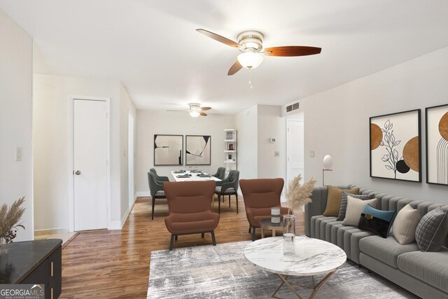 unfurnished living room with ceiling fan and dark hardwood / wood-style flooring