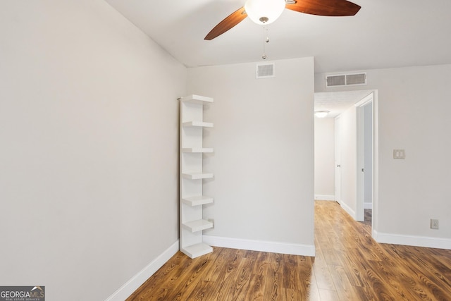 unfurnished room with ceiling fan and hardwood / wood-style flooring