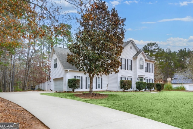 view of front property featuring a front yard and a garage