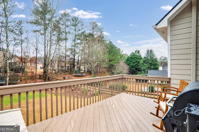 wooden deck featuring a trampoline