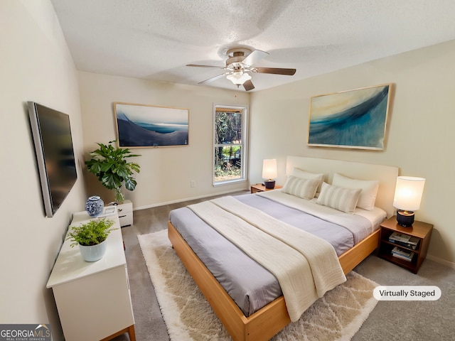 bedroom with ceiling fan, hardwood / wood-style floors, and a textured ceiling