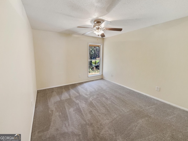 carpeted empty room featuring a textured ceiling and ceiling fan