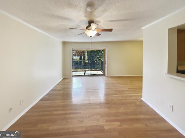 unfurnished room with wood-type flooring, a textured ceiling, ceiling fan, and ornamental molding