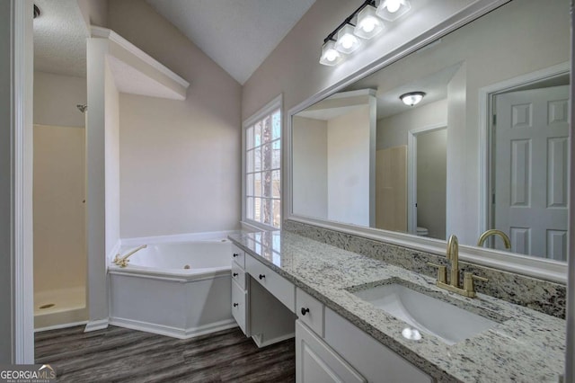 full bathroom featuring vanity, lofted ceiling, hardwood / wood-style flooring, a textured ceiling, and shower with separate bathtub