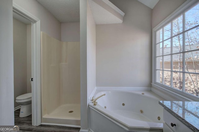 full bathroom with vanity, a textured ceiling, separate shower and tub, hardwood / wood-style floors, and toilet