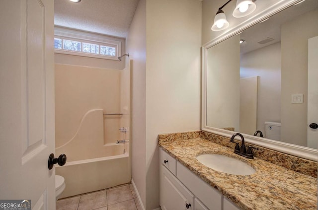 full bathroom with washtub / shower combination, tile patterned flooring, a textured ceiling, toilet, and vanity