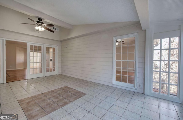 unfurnished sunroom featuring french doors and vaulted ceiling with beams