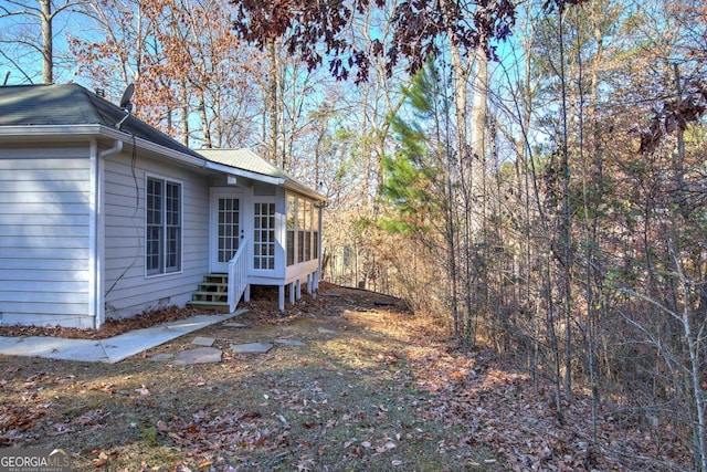 view of property exterior featuring a sunroom