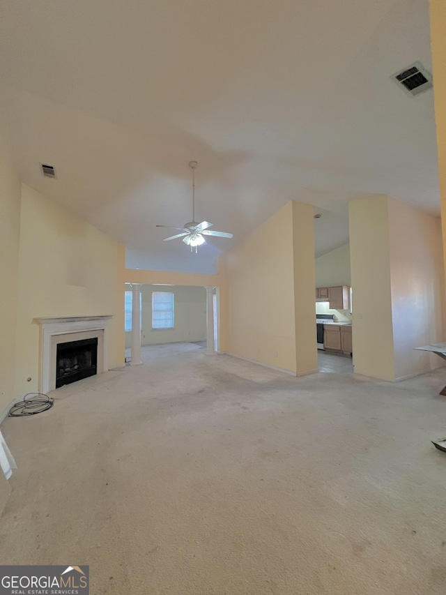 unfurnished living room featuring ceiling fan, light colored carpet, and high vaulted ceiling