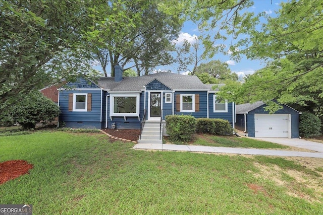 view of front of house featuring a garage and a front lawn