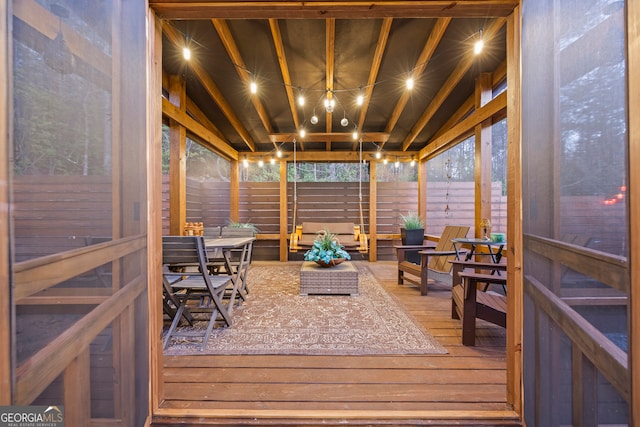 sunroom / solarium with vaulted ceiling with beams