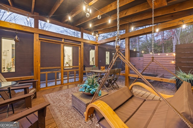 sunroom featuring beam ceiling