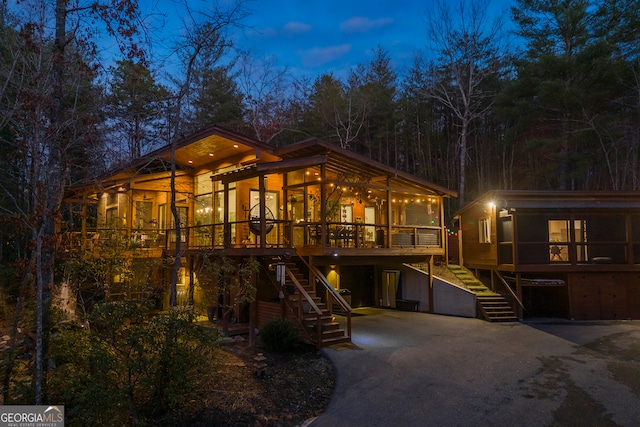 view of front of property with a sunroom and a deck