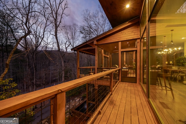 deck at dusk with a sunroom