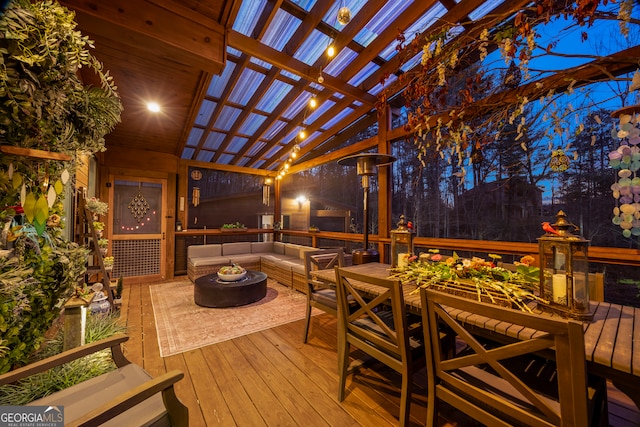 wooden terrace featuring a pergola and an outdoor living space with a fire pit