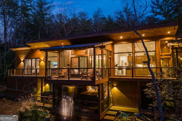 back of property with a sunroom